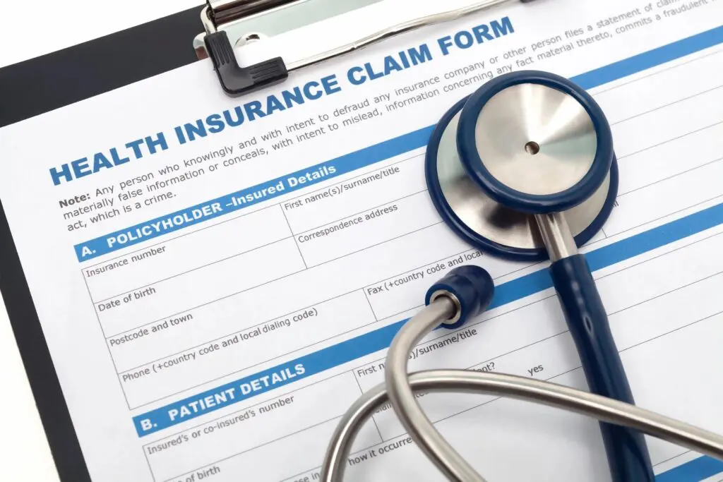 A stethoscope sitting on top of an health insurance claim form.