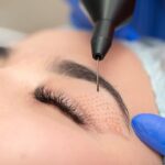 A woman getting her eyebrows waxed at the salon