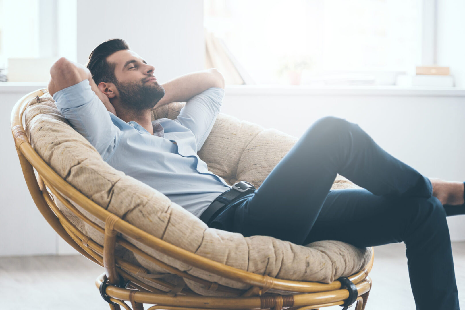 A man sitting in a chair with his eyes closed.